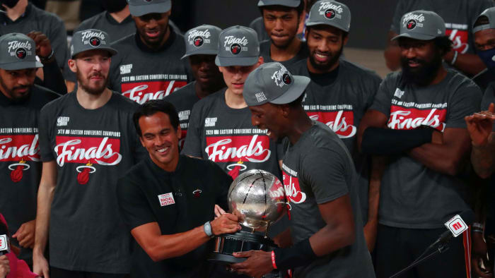 Miami Heat head coach Erik Spoelstra hands the Eastern Conference Championship trophy to forward Bam Adebayo (13) after defeating the Boston Celtics in game six of the Eastern Conference Finals of the...